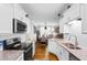 Spacious kitchen with granite countertops and sleek appliances, flows into the dining and living areas at 186 Ella Kinley Circle # 101, Myrtle Beach, SC 29588