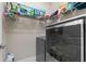 Laundry room with gray washer and dryer and storage shelves with cleaning supplies and hangers at 186 Ella Kinley Circle # 101, Myrtle Beach, SC 29588