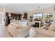 Open-concept living room featuring a fireplace, kitchen, and comfortable seating with beige furniture at 186 Ella Kinley Circle # 101, Myrtle Beach, SC 29588