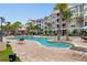 Community pool with palm trees and lounge chairs, perfect for relaxing and enjoying the sun at 186 Ella Kinley Circle # 101, Myrtle Beach, SC 29588