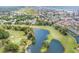 Aerial view showcasing a golf course, community buildings, a pond, marshes, and the ocean in the background at 1900 Duffy St. # H-8, North Myrtle Beach, SC 29582
