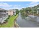Aerial view of lush community showcasing a beautiful pond and well-maintained landscaping at 1900 Duffy St. # H-8, North Myrtle Beach, SC 29582