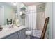 Well-lit bathroom features a vanity with a sink, storage racks, and a shower-tub combo at 1900 Duffy St. # H-8, North Myrtle Beach, SC 29582