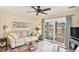 Comfortable living room with sofa and balcony access at 1900 Duffy St. # H-8, North Myrtle Beach, SC 29582
