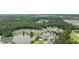 An aerial view shows the property's location near a pond and a beautiful green space at 208 Hamilton Way, Conway, SC 29526
