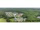 An aerial view shows a lush landscape, pond, and quiet neighborhood at 208 Hamilton Way, Conway, SC 29526