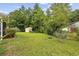 Expansive backyard with lush lawn, mature trees, and a storage shed with ample space for outdoor activities at 208 Hamilton Way, Conway, SC 29526