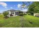 Picturesque backyard with a lush lawn, mature landscaping, a patio, and a screened porch at 208 Hamilton Way, Conway, SC 29526