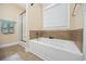 Bathroom showcasing a soaking tub and a glass-enclosed shower, perfect for relaxation at 208 Hamilton Way, Conway, SC 29526