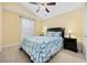 Bright bedroom with vaulted ceiling, ceiling fan, and stylish blue patterned bedding at 208 Hamilton Way, Conway, SC 29526