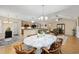 Open-concept dining area with a table that is adjacent to a well-lit kitchen and living room at 208 Hamilton Way, Conway, SC 29526