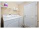 Functional laundry room equipped with washer, dryer, and shelving for storage at 208 Hamilton Way, Conway, SC 29526