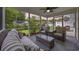 Relaxing screened sunroom with comfortable seating, a ceiling fan, and views of the fenced backyard at sunset at 208 Hamilton Way, Conway, SC 29526