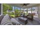 Relaxing screened sunroom with comfortable seating, a ceiling fan, and views of the fenced backyard at 208 Hamilton Way, Conway, SC 29526
