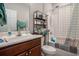 Bathroom features wood vanity, shower and tub with blue and gray accents at 2472 Bayboro St. # C, Loris, SC 29569