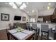 Open-concept dining area featuring modern lighting, table set, and views into the living area at 2472 Bayboro St. # C, Loris, SC 29569
