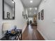 Inviting hallway with wood floors, decorative wall hangings and open view to the living room at 2472 Bayboro St. # C, Loris, SC 29569