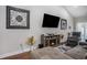 Cozy living room with a fireplace, mounted television, and contemporary furnishings at 2472 Bayboro St. # C, Loris, SC 29569