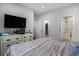 Neutral main bedroom with mounted TV, double door closet and attached bathroom with step in shower at 2472 Bayboro St. # C, Loris, SC 29569