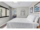 Comfortable bedroom with a cozy bed, chair, and a window providing natural light and fresh air at 2500 N Ocean Blvd. # 1102, Myrtle Beach, SC 29577