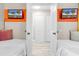 View through a bedroom doorway with twin beds and a mounted television at 2500 N Ocean Blvd. # 1102, Myrtle Beach, SC 29577