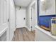 Hallway with blue accent wall and plank flooring showcasing doors and entryway at 2500 N Ocean Blvd. # 1102, Myrtle Beach, SC 29577