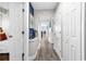 Hallway with blue accent wall and plank flooring leading towards the living area with a view of the ocean at 2500 N Ocean Blvd. # 1102, Myrtle Beach, SC 29577