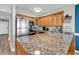 Bright kitchen featuring stainless steel appliances, wooden cabinetry, and granite countertops at 2500 N Ocean Blvd. # 1102, Myrtle Beach, SC 29577
