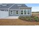 New construction townhome featuring gray siding, a concrete patio and a yard at 2616 Elowen Ln. # 167B, Longs, SC 29568