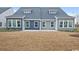 New construction townhome featuring gray and blue siding, a patio and a large backyard at 2616 Elowen Ln. # 167B, Longs, SC 29568