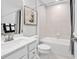 Bright bathroom featuring white cabinetry, shower/tub combo, and decorative artwork at 2616 Elowen Ln. # 167B, Longs, SC 29568