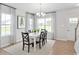 Bright dining room featuring white table, elegant chandelier, and views from surrounding windows at 2616 Elowen Ln. # 167B, Longs, SC 29568