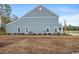 Side view of a new construction house showing the siding, windows and backyard at 2616 Elowen Ln. # 167B, Longs, SC 29568