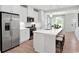 Modern kitchen featuring stainless steel appliances, white cabinets and large island with seating at 2616 Elowen Ln. # 167B, Longs, SC 29568