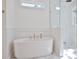 Elegant white freestanding bathtub with gold fixtures next to a modern glass shower at 2729 Long Avenue Ext., Conway, SC 29526