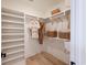 Organized walk-in closet with custom shelving, storage baskets and wooden floors at 2729 Long Avenue Ext., Conway, SC 29526
