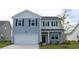 Charming two-story home with a two-car garage, black shutters, and landscaped front yard at 2851 Riverboat Way, Conway, SC 29526
