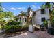 Exterior view of the house showcasing the brick patio, greenery, and large stone chimney at 309 Sunset Trail, Myrtle Beach, SC 29577