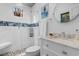 Well-lit bathroom with a glass shower, white tile, decorative blue accents and granite vanity at 309 Sunset Trail, Myrtle Beach, SC 29577