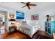 Inviting bedroom boasts wood floors, ceiling fan, and cozy decor with an ensuite doorway at 309 Sunset Trail, Myrtle Beach, SC 29577