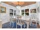 Charming dining room featuring a crystal chandelier, wood-paneled ceiling, and a classic white table setting at 309 Sunset Trail, Myrtle Beach, SC 29577