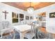 Elegant dining room with wood ceiling, crystal lighting, and white table, perfect for memorable gatherings at 309 Sunset Trail, Myrtle Beach, SC 29577