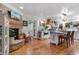 Bright, open-concept living area with brick fireplace, wood floors, and a gourmet kitchen in a stylish, welcoming home at 309 Sunset Trail, Myrtle Beach, SC 29577