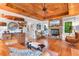 Cozy living room featuring a stone fireplace, wood-paneled ceiling, and stylish, comfortable seating arrangement at 309 Sunset Trail, Myrtle Beach, SC 29577