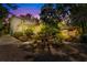 Charming outdoor patio and garden featuring lush landscaping, lighting, and comfortable seating at 309 Sunset Trail, Myrtle Beach, SC 29577