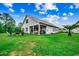 Lush backyard with manicured lawn featuring outdoor seating, barbeque, and mature trees at 3091 Viceroy Loop, Little River, SC 29566
