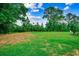 Expansive backyard features a lush lawn and mature trees, creating a serene and private oasis at 3091 Viceroy Loop, Little River, SC 29566