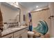 Charming bathroom features a decorative mirror, sink with granite, and shower with surfboard curtain at 3091 Viceroy Loop, Little River, SC 29566