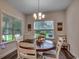 Cozy dining area with a wooden table, comfortable seating, and natural light streaming through the windows at 3091 Viceroy Loop, Little River, SC 29566