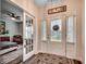 Well-lit foyer featuring hardwood floors, glass front door, and view into the bedroom at 3091 Viceroy Loop, Little River, SC 29566